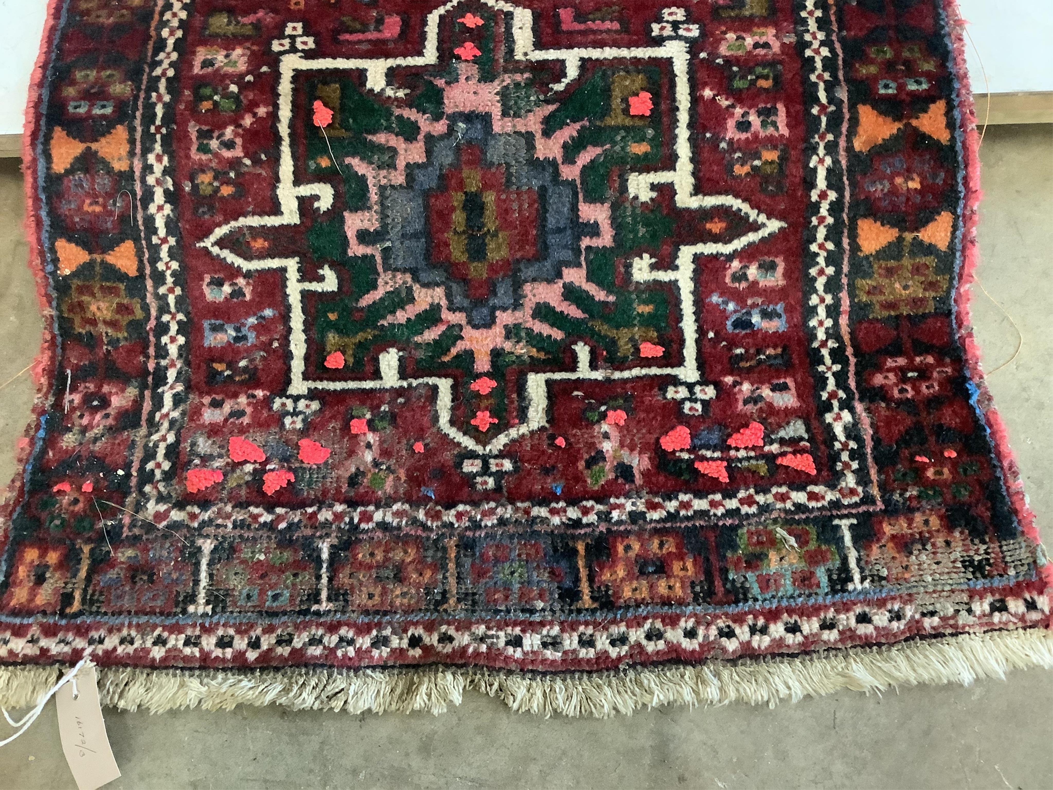 A Persian dark red ground runner, 386 x 88cm. Condition - poor, worn at both ends